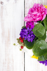 bouquet of colorful flowers on white wooden planks