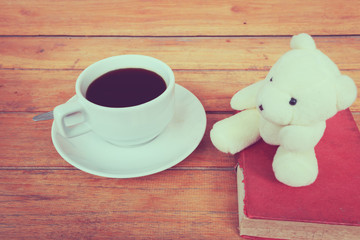 a cup of coffee on a wooden, process color.