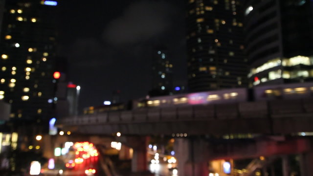 de-focus skytrain transportation in city urban lifestyle at night