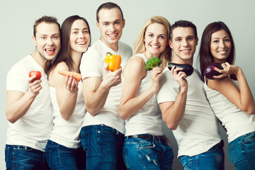 Happy veggies concept. Group portrait of healthy boys and girls