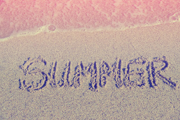 Word Summer on beach sand.Special toned photo in retro style