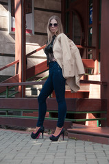 Young blonde girl posing in the street