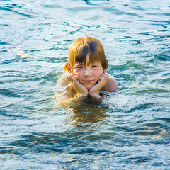 boy has fun in the ocean