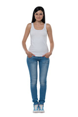 Full length of a brunette woman in a white tank top and jeans. Isolated.