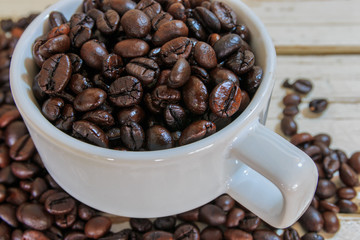 coffee beans in a white coffee cup, selective focus