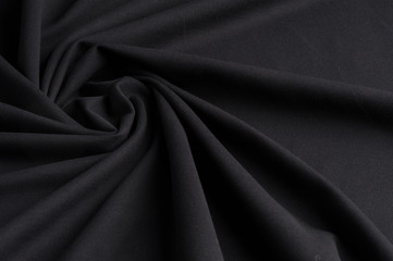 Spiral folds on black cloth