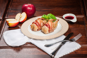 Two fried quails with bacon