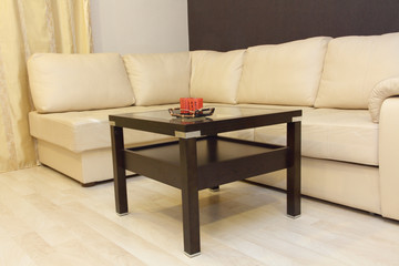 Comfortable white corner leather sofa and coffee table.