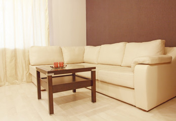 Beige corner leather sofa and coffee.