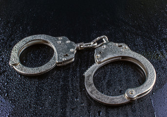 police handcuffs in the drops of rain