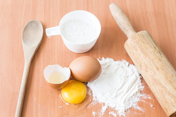 Ingredients for baking cake with egg on a wooden worktop