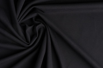 Spiral folds on black cloth