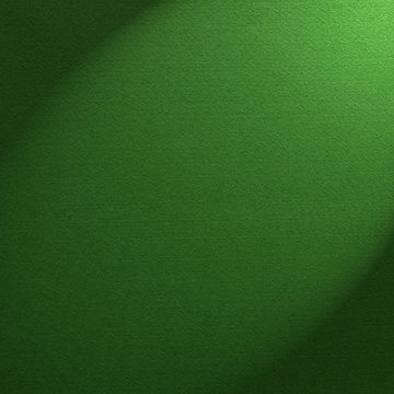 Green felt background illuminated by a spotlight
