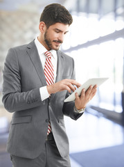 Confident businessman with digital tablet