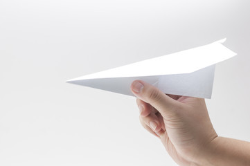 woman's hand take the paper plane