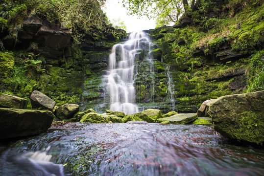Amazing waterfall and river in green valley in Peak District