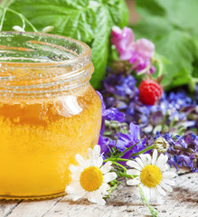 Honey and herbs on a wooden table, summer and healthy eating con