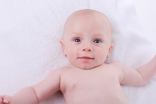 isolated portrait of young happy smiling baby on a white background