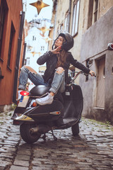 Fototapeta na wymiar Sexy good looking girl posing on stylish scooter.