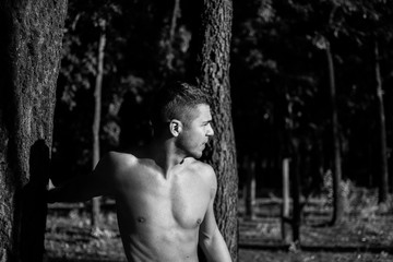 Man photographed in street workout session. Photo was taken in early morning, around 6am in city park Dudova forest. Black and white photo.