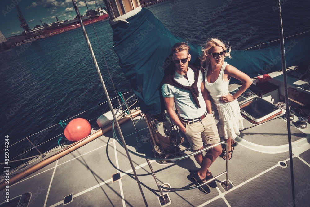 Wall mural Stylish wealthy couple on a yacht