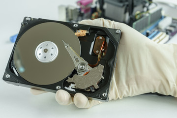 opened hard disk drive in hand