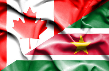 Waving flag of Suriname and Canada
