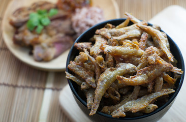Dry fish with roast pork background