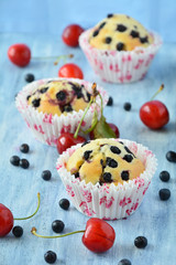 Blueberry muffins on blue wooden background