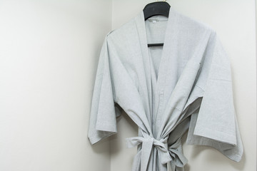 gray bathrobe hanging in the closet