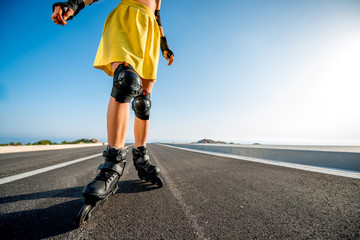 Sport woman with rollers on the highway