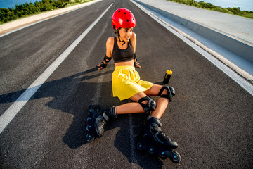 Sport woman with rollers on the highway