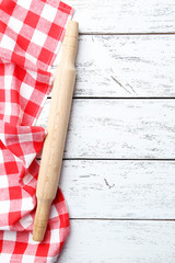 Empty wooden table with rolling pin and napkin on white backgrou