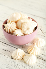 French meringue cookies on white wooden background