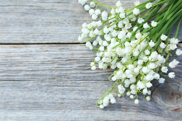 Lily of the Valley on grey wooden background