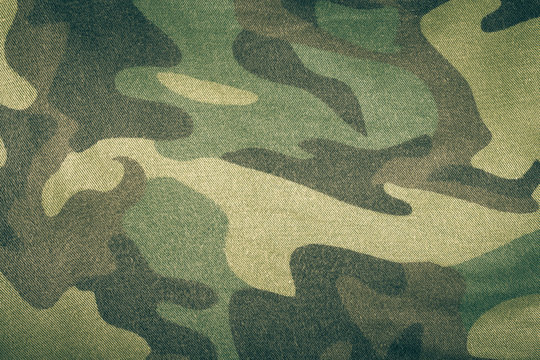 Fabrics with camouflage pattern. Background. Toned