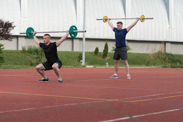 Young People Doing A Overhead Squat Exercise Outdoor