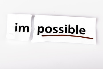 The word impossible changed to possible on torn paper