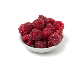 Ripe raspberry on a saucer. Isolated on white background