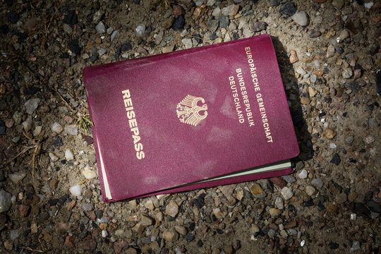 lost passport  lying on a dark sandy ground