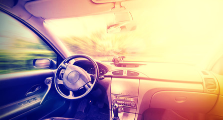 Vintage toned picture of a driving car interior.