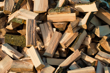 firewood background - chopped firewood on a stack