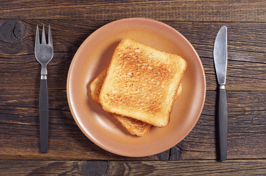 Toasted bread, fork and knife