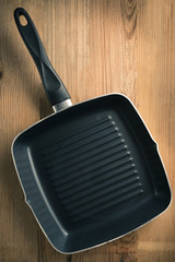 The pan on the wooden floor with retro tone