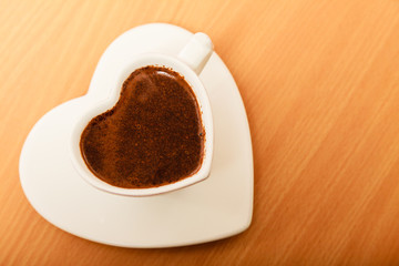Coffee in heart shaped cup mug. Caffeine energy.