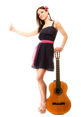 girl with guitar thumbing and hitch hiking isolated