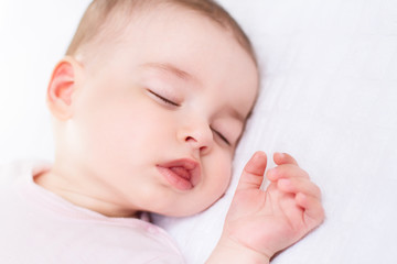 Close-up portrait of a beautiful sleeping baby on white