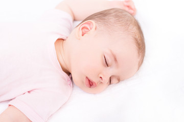 Close-up portrait of a beautiful sleeping baby on white
