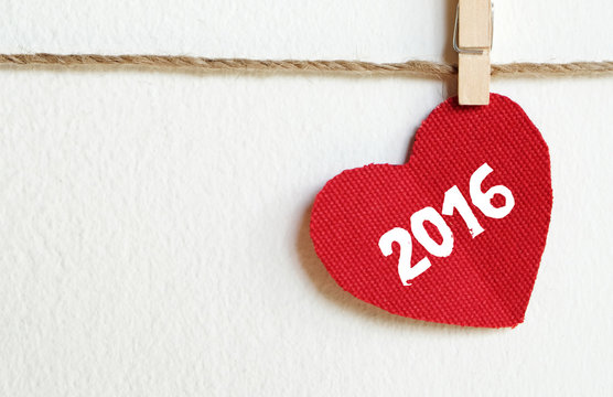 Red fabric heart with 2016 word hanging on the clothesline