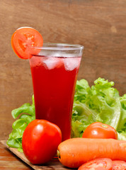 Fresh vegetable juices on wooden table